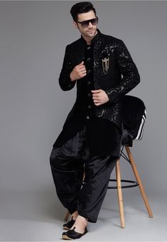 Bollywood Style Winter Sets With Intricate Embroidery, Bollywood Style Embroidered Winter Sets, Bollywood Black Sherwani For Eid, Bollywood Style Black Sherwani For Eid, Black Semi-stitched Bandhgala For Eid, Black Semi-stitched Bandhgala For Diwali, Black Semi-stitched Bandhgala For Festive Occasions, Festive Semi-stitched Black Bandhgala, Black Bandhgala With Traditional Drape For Designer Wear