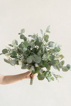 a person holding a bunch of flowers in their hand