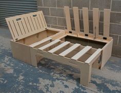 a wooden bed frame sitting next to a brick wall