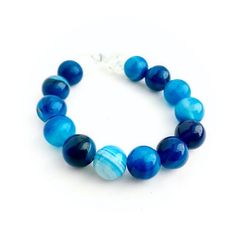 A beautiful blue rainbow in these agate gemstone beads! This bracelet is beaded on clear strong elastic, and measures about 7 inches inside. Crackle glass beads on the ends. This bracelet will go perfect with any blue outfit! The variety of shades of blue definitely stand out! Blue Gemstone Bracelet, Dyed Agate, Bullet Earrings, Green Beaded Bracelets, Semiprecious Stone Jewelry, Blue Beaded Bracelets, Hippie Bracelets, Chakra Jewelry, Blue Rainbow