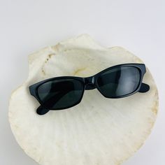 These chic cat eye sunglasses are your everyday classic. Featuring a black frame with black smoke lens. This style is unisex. True genuine vintage sunglasses from the 90s. - 400 uv - new vintage from the 90s - includes sunglasses pouch Available in other colors Red tortoise https://etsy.me/30WoyTI Brown Tortoise https://etsy.me/37PsEx8 Vintage Cat Eye Sunglasses With Anti-reflective Coating, Retro Black Sunglasses With Gradient Lenses, Black Retro Sunglasses With Gradient Lenses, Retro Black Sunglasses With Mirrored Lenses, Retro Black Sunglasses With Uva Protection, Vintage Cat Eye Sunglasses With Uva Protection, Black Retro Sunglasses With Uva Protection, Vintage Black Sunglasses For Summer, Retro Cat Eye Wayfarer Sunglasses With Uv Protection