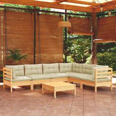 an outdoor living area with wooden furniture and bamboo blinds