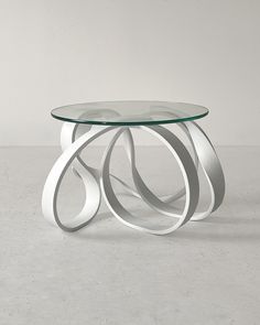 a glass table sitting on top of a white floor