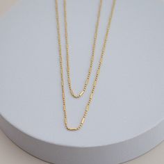 the namesake of our shape of you collection, this necklace embodies the concept behind the collection: taking it back to basics with simple, everyday, elevated pieces. 18kt gold BR gold filled available in 16" or 18" in length Minimalist 14k Gold-filled Figaro Chain Necklace, Classic Everyday 14k Gold Filled Charm Necklaces, Minimalist Double Strand Everyday Necklaces, Minimalist Layered Necklace With Satellite Chain, Dainty 14k Gold Filled Necklace For Everyday, Everyday 14k Gold Filled Gold Necklaces, Everyday 14k Gold Filled Cable Chain Necklace, Minimalist Tarnish-resistant Necklace For Layering, Minimalist Double Strand Charm Necklace