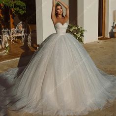 a woman in a wedding dress is posing for the camera with her hand on her head