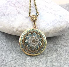 Antique style teal locket pendant. This locket is the perfect gift for her. Beautiful filigree handcrafted brass locket with a glass like resin finish. The locket measures approx 31mm and is hanging on an antiqued brass chain, please choose your length at checkout.   Inside of the locket are two spaces for photo's etc to be glued in.  The locket will arrive in a little gift box  ready for giving. Gorgeous quality and details. Would highly recommend as a special gift So beautiful!! Honestly it's Antique Gold Bohemian Locket Necklace, Bronze Bohemian Locket Necklace, Handmade Brass Locket Necklace For Vintage Collection, Bohemian Brass Locket Necklace, Antique Gold Medallion Locket Necklace In Bohemian Style, Antique Gold Bohemian Medallion Locket Necklace, Bohemian Brass Medallion Locket Necklace, Bohemian Antique Gold Medallion Locket Necklace, Bohemian Medallion Locket Necklace