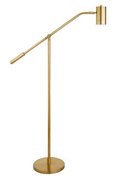 a brass colored floor lamp with a dimmer on the side and a white background