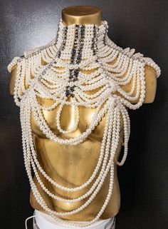 The pearl and rhinestone statement necklace is a stunning piece of jewelry that is sure to make a bold impression. The necklace features a combination of pearls and rhinestones, which create a striking contrast and add a touch of glamour and sophistication to any outfit. It's perfect for formal events and can be worn with a variety of different outfits, from dresses to blouses and even t-shirts. This necklace is truly a statement piece that is sure to turn heads wherever you go! Chic Pearl Necklaces For Party, Glamorous Pearl Chain Jewelry For Party, Glamorous Party Pearl Chain Jewelry, Chic Pearl Drop Necklace For Party, Chic Evening Pearl Necklace, Glamorous Pearl White Jewelry For Party, Evening Pearl Embellished Choker Necklace, Glamorous Pearl White Party Jewelry, Elegant Beaded Bib Necklace For Evening