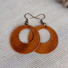 These modern and minimalist leather circle earrings are the perfect look for everyday. Create your own custom earrings by choosing from the 10 leather options then pair them with ear wires in antique brass, antique silver, or antique copper. Lightweight and easy to wear - you might forget you are wearing them!  I use only genuine full grain vegetable tanned leather chosen for its high quality and excellent durability. The leather will age beautifully and develops fabulous character over time.  D Vintage Leather Strap Jewelry For Everyday, Classic Round Leather Jewelry, Everyday Vintage Jewelry With Leather Strap, Modern Jewelry With Leather Strap For Everyday, Everyday Brown Leather Strap Jewelry, Classic Everyday Leather Jewelry, Everyday Brown Jewelry With Waxed Finish, Handmade Leather Hoop Earrings, Handmade Minimalist Leather Earrings