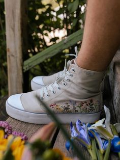 Our Wildflower Wanderer Platform High Tops have beautifully embroidered wildflowers on the outside of both shoes. The sole is 1.5 inches (our normal shoes have 0.9 inch soles) and the high top part around your ankle is ~ 1 inch higher than our normal high tops. This shoe color is our london fog, which is light grey. We spot clean our shoes with natural soap, water, a cloth (or toothbrush!) and a bit of elbow grease. We recommend doing a spot test before cleaning with any soap to make sure that t Platform High Tops, Bangs Shoes, Embroidered Canvas, London Fog, Natural Soap, Unisex Design, Grease, High Top, Wild Flowers