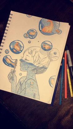 a drawing of a girl blowing bubbles with her eyes closed and two colored pencils next to it