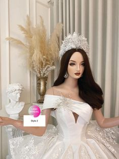 a barbie doll wearing a wedding dress and tiara in front of a white wall