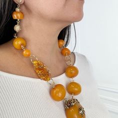 Amber Necklace. Embellished with Swarovski Crystals Necklace Earring Set. TWO OF A KIND DESIGNMETAL: Stainless SteelAPPROX SIZE: 22" Adjustable Length - Earring 2"CLOSURE: Lobster Claw Clasp Amber Round Beads Jewelry For Formal Occasions, Formal Amber Jewelry With Round Beads, Unique Amber Jewelry With Matching Earrings, Luxury Amber Jewelry With Matching Earrings, Luxury Handmade Orange Jewelry, Amber Round Beaded Jewelry, Amber Jewelry With Large Beads, Amber Jewelry With Large Round Beads, Round Amber Jewelry With Large Beads