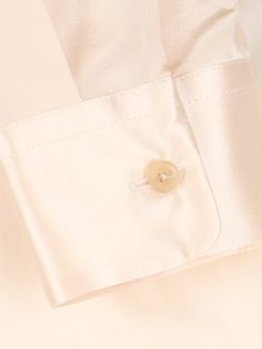 Khaite cream silk shirt with classic collar, button closure, button cuffs, curved hem. Composition: 100% Silk Elegant Beige Tops For Business, Elegant Beige Business Top, Elegant Beige Business Tops, Luxury Cream Tops For Work, Luxury Cream Top For Workwear, Luxury Cream Top For Work, Elegant Silk Shirt With Fold Down Collar, Elegant Beige Silk Blouse, Elegant Silk Shirt With Fold-down Collar