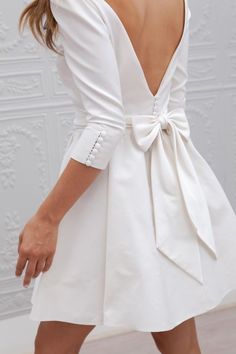 a white dress with a bow on the back