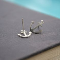 Delicate anchor studs make the sweetest addition to any outfit. Your ears will just love to show them off! These anchor earrings are an original design by Lola&Cash. For a really cute combo, check out the necklace of same design over here: https://www.etsy.com/listing/97852651/anchor-necklace-sterling-silver-anchor -d e s c r i p t i o n- The petite anchors were hand pierced from sterling silver sheet & then filed smooth. Sturdy ear pins are soldered to the back & then the earring is Hand Piercing, Anchor Earrings, Nautical Earrings, Anchors Aweigh, Alpha Sigma, Artisan Jewelry Handmade, Anchor Necklace, Ear Pins, Love Jewelry