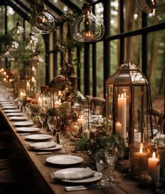 a long table is set with candles and plates