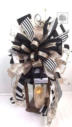 a lantern decorated with black and white ribbons