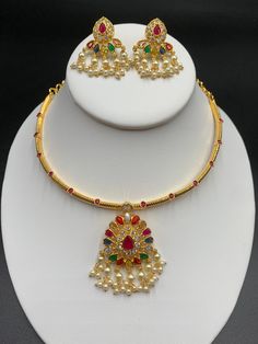 Unique style kante with navarathna Stones pendant and matching earrings Handmade jewelry One gram gold jewelry Silver plated jewelry Official Website globusfashions.com 🌸 S H O P . M O R E . S T Y L E S 🌸 https://www.etsy.com/shop/Globusfashions Necklaces - https://www.etsy.com/shop/Globusfashions?section_id=18712263 Bracelets - https://www.etsy.com/shop/Globusfashions?section_id=18969767 Pendant Sets - https://www.etsy.com/shop/Globusfashions?section_id=18707402 Tikka - https://www.etsy.com/s Gold Plated Temple Jewelry Set For Puja, Gold Plated Temple Jewelry Sets, Temple Jewelry Style Gold Plated Jewelry Sets For Celebration, Gold Plated Temple Jewelry Sets For Celebration, Temple Style Gold Plated Jewelry Sets For Celebration, Festive Temple Jewelry Sets For Celebration, Festive Celebration Temple Jewelry Sets, Temple Jewelry Sets With Latkans For Celebration, Gold Plated Temple Necklace For Celebrations And Festivals