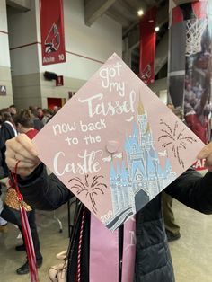 a woman holding up a pink graduation cap that says got only tassel to the castle