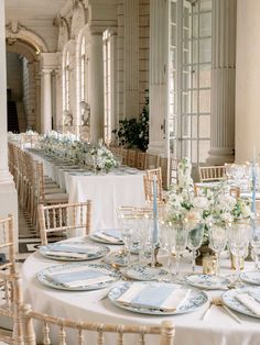 the tables are set with white and blue place settings