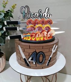 a birthday cake that is made to look like a barrel with meats and vegetables on it