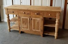 a kitchen island made out of wood with drawers