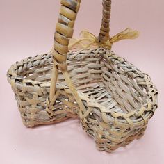 two wicker baskets sitting on top of a pink surface