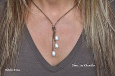 This is a 3 Pearl Lariat made with Large 14-15mm White Freshwater Rice Pearls on any color of 2mm Leather that you choose.  The neck part is 18 inches and the Lariat part with the pearls hangs another 2.5 inches. The clasp is a magnetic stainless steel with a safety turn.  *  If you want the neck part another size please comment when ordering. *  There are many options for matching earrings.  Here is the link to those in the photos. https://www.etsy.com/listing/1583993833/leather-and-pearl-rice-pearl-earrings? ** A great start or addition to your Pearl and Leather Jewelry Collection.  The Pearl and Leather Necklace in the photos has sold, but represents what you will receive. Adjustable Lariat Necklace With Pearl Charm, White Adjustable Lariat Necklace With Pearl Charm, White Adjustable Lariat Necklace With Pearl Pendant, Silver Lariat Pearl Necklace With Adjustable Chain, Rice Pearl Earrings, Black Pearl Leather Necklace, Pearl Lariat, Rice Pearls, Necklace Leather