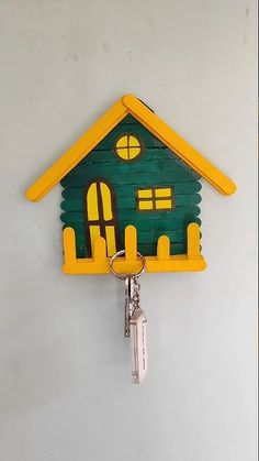 a green and yellow house shaped key holder