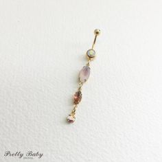 gold belly ring, opal belly ring, peach belly ring, irridescent, swarovski, opal, Belly button ring, bellybutton ring, dangle belly ringPLEASE SEE SHIPPING TAB FOR TURNAROUND TIMEPretty belly ring in surgical steel colored GOLDwith a double gem in ABwith vintage swarovski and rhinestone brass prong set glass crystal dangles in peach, opalescent peach/topaz, and iridescententire piece approx 2 3/4" long. / 7 cm14 gaugeLarge barbell rhinestone approx 7mm acrossComes in an organza gift bagTo keep t Belly Pierce, Bellybutton Ring, Gold Belly Button Rings, Cute Belly Rings, Opal Belly Ring, Piercing Chart, Bellybutton Piercings, Belly Button Piercing Jewelry, Belly Piercing Jewelry