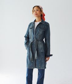 A stretchy, lightweight denim duster jacket, with a belted waist and faded wash.  By Armor Jeans.  Measures: Across Shoulders: 16" Chest: 40-42" Waist: 36" Length: 36" Sleeve: 25" Condition: Excellent.  FOLLOW US ON INSTAGRAM FOR DEALS AND SNEAK PEEKS! @Wildthingvintage instagram.com/wildthingvintage Twitter: @Wildthingpeck Message me any time for further details or questions. Please note there is a 10% restocking fee on orders cancelled prior to shipment. Returns are upon a case by case basis, Belted Denim Jacket For Workwear, Utility Style Denim Belted Outerwear, Utility Style Denim Outerwear With Belt, Utility Denim Outerwear With Belt, Utility Style Belted Denim Outerwear, Denim Utility Outerwear With Belt, Belted Denim Blue Denim Outerwear, Casual Denim Belted Outerwear, Casual Belted Denim Outerwear