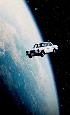 an old car flying over the earth in space