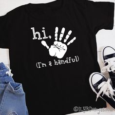 Hi five! It's your 5th birthday! Celebrate this milestone birthday with a stylish Hi Five I'm a Handful Handprint Birthday t-shirt. SIZE: 2T 3T 4T 5/6 XS youth S youth M youth L youth XL youth T-SHIRT COLOR: red navy black LETTER COLOR: white MATERIAL: 100% preshrunk cotton heat transfer vinyl CARE INSTRUCTIONS: DO NOT dry clean wash inside out in cold or warm water use mild detergents dry on low setting DO NOT iron directly onto design ••••••••••••••••••••••••••••••••••••••••••••••••••••••••••• Father's Day Black T-shirt With Funny Print, Black Top With Text Print For Birthday, Black Tops With Text Print For Birthday, Family Matching Black Screen Print T-shirt, Black Family Matching T-shirt With Screen Print, Black T-shirt With Name Print For Family Matching, Black Family Matching T-shirt With Name Print, Casual Black T-shirt For Birthday, Black T-shirt With Name Print For Birthday