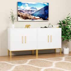 a living room scene with focus on the sideboard and large screen television mounted above it