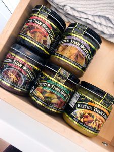 several jars of food sitting on top of a wooden shelf