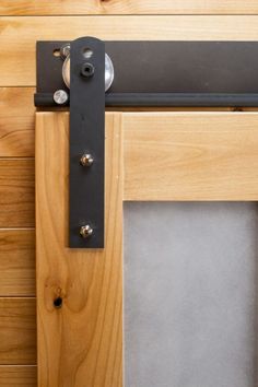 a close up of a wooden door with a metal handle on the front and side