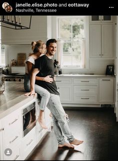 a man and woman standing on top of a kitchen counter