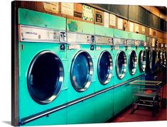 a row of green washers in a public laundment