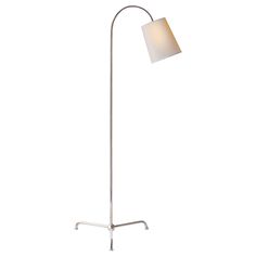 a floor lamp with a white shade on it