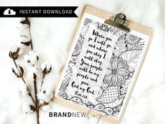 a clipboard with a quote on it next to some cotton flowers and a plant