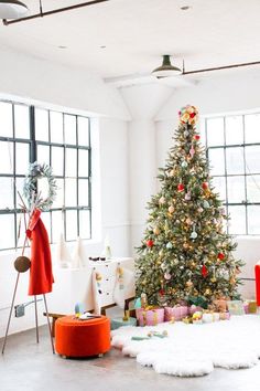 a decorated christmas tree in an empty room