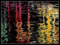 the reflection of colorful lights on water