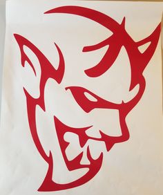 a red and white paper bag with an image of a demon's head on it