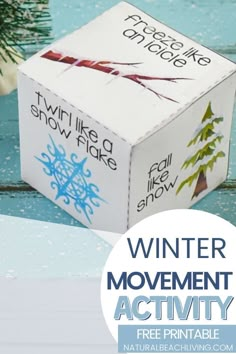 a white box with blue writing on it next to a christmas tree and snowflakes