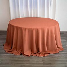 a round table with an orange cloth on it