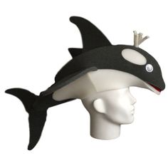 a white mannequin head wearing a black hat with a shark on it