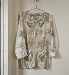 "Vintage embroidered openwork rayon shirt jacket Made in Indonesia by Bali Emerald High quality craftsmanship; real mother of pearl button Marked size small; runs fairly large. Please view measurements Excellent vintage condition; no major flaws noted. Tiny light mark noted on end of sleeve. Appears clean and well cared for. Approximate measurements 19.5\" shoulder to shoulder 21\" pit to pit lying flat 28\" length 20.25\" sleeve lengtg All items are sold as is with no returns and no partial ref Cream Floral Embroidery Cardigan For Spring, Cream Floral Embroidered Cardigan For Spring, Beige Button-up Summer Cardigan, Beige Embroidered Cardigan For Spring, Spring Beige Embroidered Cardigan, Embroidered Cream Outerwear For Summer, White Embroidered Cardigan For Spring, Cream Embroidered Summer Outerwear, Summer Cream Embroidered Outerwear