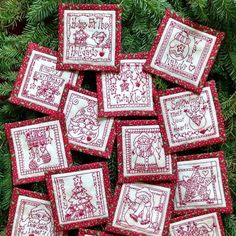 twelve red and white christmas coasters with santa's sleigh on them