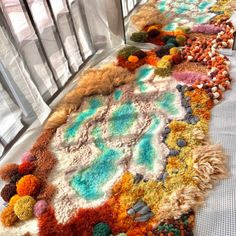 several colorful rugs are lined up on the floor